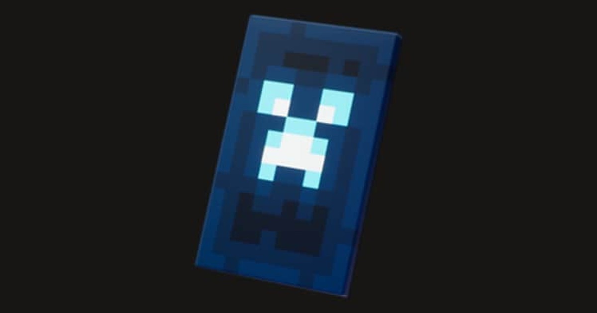 The Corrupted Creeper Cape — a glowing pale-cyan charged creeper face on deep navy, Mojang's official render
